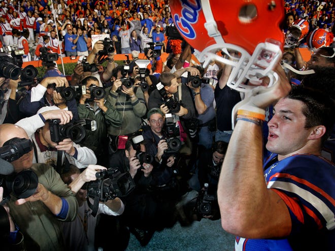 Florida's Tim Tebow sings to fans in front of many photographers following the Gators 45-12 victory over FSU at Ben Hill Griffin Stadium in Gainesville Saturday, November 24, 2007.