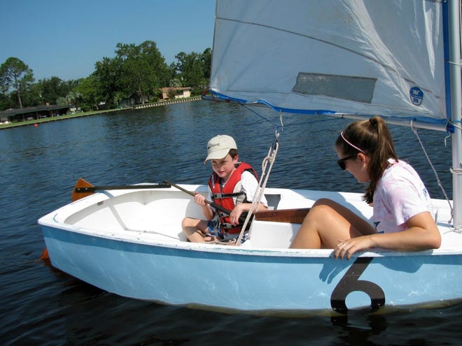 Worth Culver of Ortega gets some sailing tips from 17-year-old Jordan Robbins, an instructor at the Jacksonville Yacht Club.