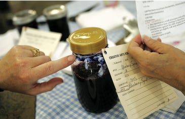 Photo by Daniel Freel/New Jersey Herald Judges examine home-made blueberry syrup during the One and Only Blueberry Contest at the New Jersey State Fair/Sussex County Farm and Horse Show held recently at the fairgrounds in Frankford.