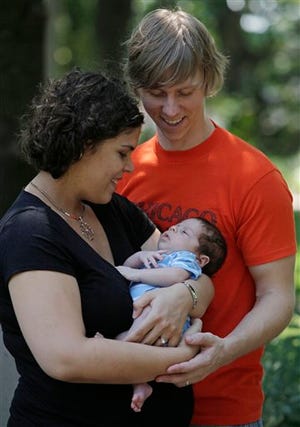 Jay and Megan Mkrtschjan hold their month old son Seth, Monday, Aug. 3, 2009 in Wheaton.