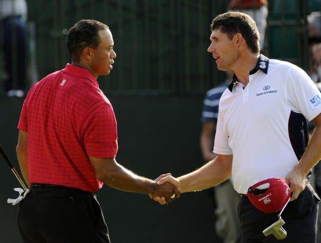 Tiger Woods, left, shakes hands with playing partner Padraig Harrington, of Ireland, after the final round of the Bridgestone Invitational golf tournament Sunday, Aug. 9, 2009, at Firestone Country Club in Akron, Ohio. Woods finished at 12-under par to beat Harrington and Robert Allenby by four shots.