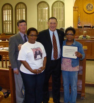 (From left to right) Parish Councilman Kent Schexnaydre (District 2), Linda Stewart Narcisse, Parish President Tommy Martinez and Sherryll Stewart pose at the Thursday, July 30 Parish Council meeting in Donaldsonville with a certificate honoring the late Edward Stewart Sr. for his community service. Mr. Stewart was the father of Narcisse and Sherryll Stewart.