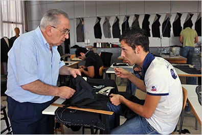 A teacher explained the art of tailoring to a student at the Brioni tailoring school in Italy.