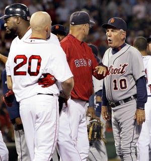 Tigers manager Jim Leyland (right) speaks to Red Sox manager Terry Francona (middle) as Kevin Youkilis (20) is held back by David Ortiz.