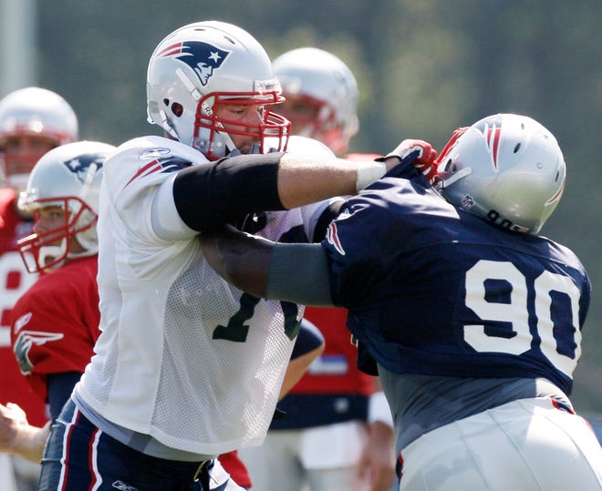 Promising rookie offensive tackle Sebastian Vollmer, left, takes on defensive lineman Le Kevin Smith during practice.