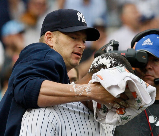 New York Yankees' A.J. Burnett, left, smears a towel full of shaving cream in Robinson Cano's face after Cano hit the game-winning RBI single in the 11th inning of their 4-3 victory over the Toronto Blue Jays in a baseball game at Yankee Stadium Wednesday, Aug. 12, 2009 in New York. (AP Photo/Kathy Willens)