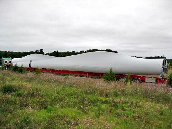 A 150-foot-long wind turbine blade arrives at the Massachusetts Military Reservation Wednesday. The entire turbine will stand at 398 feet.