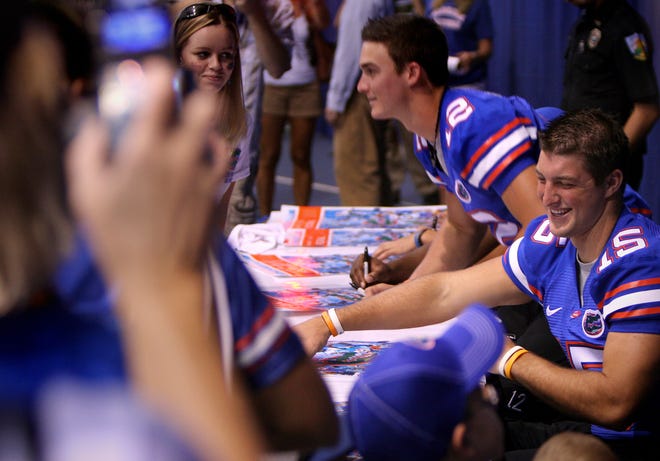 Florida junior quarterback Tim Tebow signs autographs along with fellow quarterback John Brantley during last years Gator Football Fan Day at the Stephen C O'Connell Center.