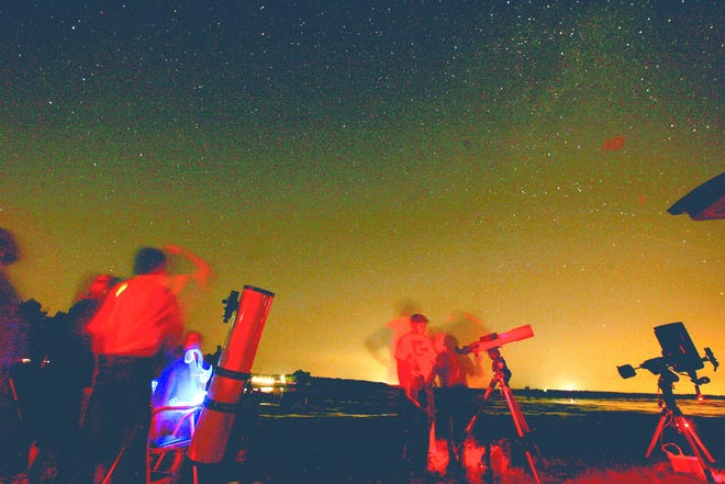 Members of the Sangamon Astronomical Society set up telescopes on the shores of Thompson Lake at The Nature Conservancy’s Emiquon Preserve near Havana on Tuesday, Aug. 11, 2009.