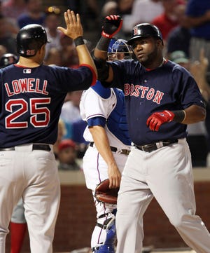 Boston's David Ortiz, right, is congratulated by teammate Mike Lowell (25) after hitting a two-run home run in the sixth inning against the Texas Rangers Friday in Arlington, Texas. (AP Photo/Tim Sharp)