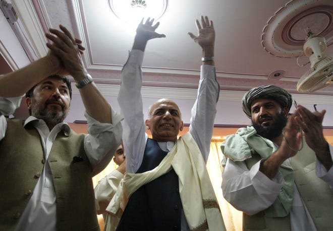 Afghan presidential candidate and former Finance Minister Ashraf Ghani Ahmadzai (center) waves to supporters in the southern city of Kandahar during an election campaign stop Saturday. Afghans will head to the polls Thursday.