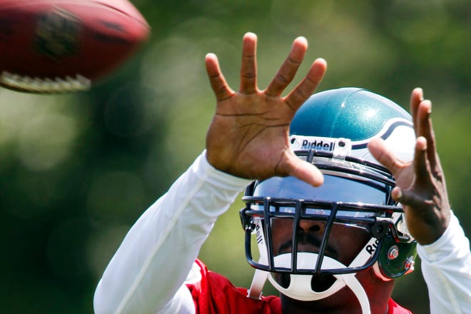 Philadelphia Eagles quarterback Michael Vick catches a ball during afternoon practice at NFL football training camp in Philadelphia on Saturday.