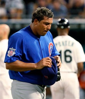 Chicago Cubs pitcher Carlos Zambrano, of Venezuela, walks off the field at the end of the third inning of a baseball game against the Florida Marlins on Saturday, Aug. 1, 2009, at Land Shark Stadium in Miami. Zambrano left the game after three innings because of a stiff back. (AP Photo/Wilfredo Lee)