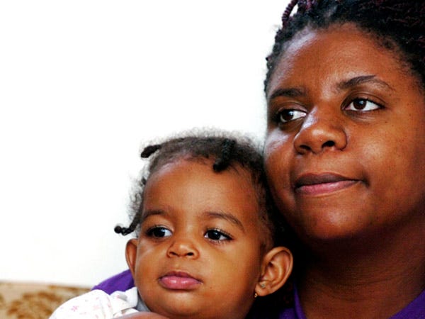 Terri, 28, holds her daughter Jasani, 17 months, at her Wilmington apartment Thursday, Aug. 13, 2009. Terri kept a food diary to see what her family is missing in their diet and their food struggle.