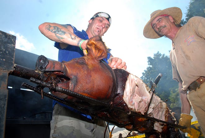 BOZRAH 8/15/2009
Dean Denis of Lebanon, left, and Marty Stefanovicz of Bozrah, right, cut meat from their pig after cooking it from a hommade electric spit during the Bozrah Moose Lodge annual pig roast Saturday, August 15, 2009. Denis and Stefanovicz participated as part of the 5-member "Snake Meadow Indian Ranch" team, led by Denis.
Tali Greener/Norwich Bulletin