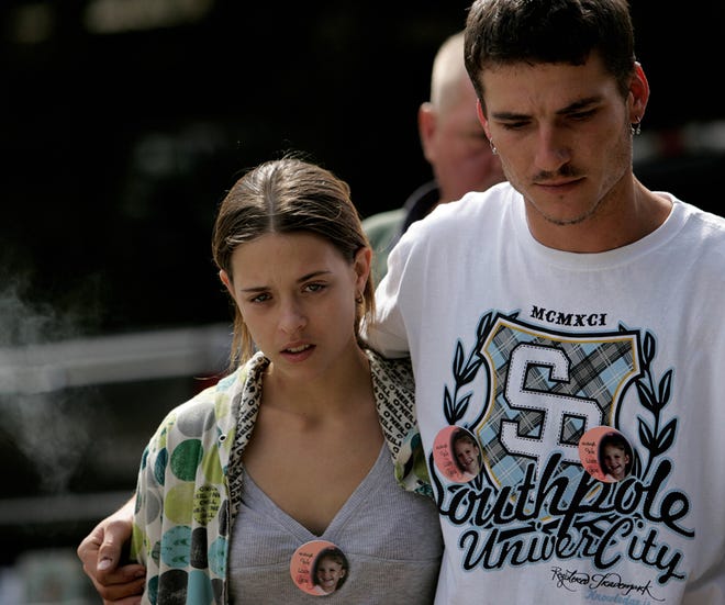 Misty Croslin, left, the girlfriend of Ronald Cummings, at right, the father of missing 5-year-old Haleigh Ann-Marie Cummings, walks up to the media to talk in this Feb. 12, 2009 file photo.