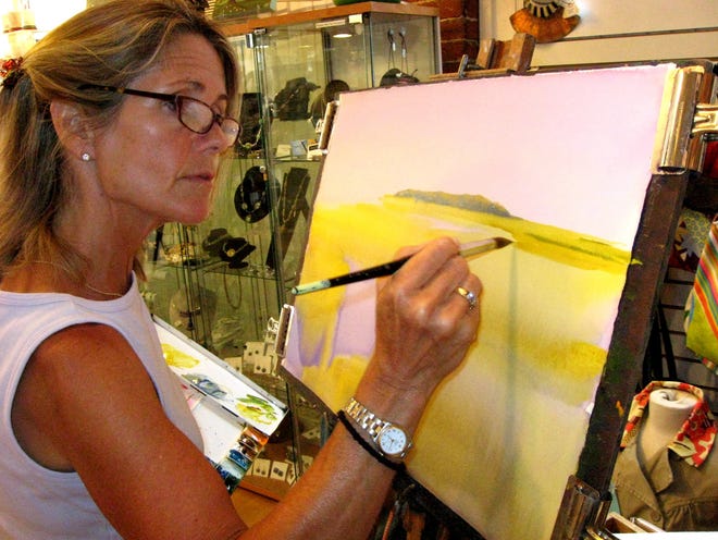 Nancy Walton of Needham works on "Reflections on a Marsh" during the monthly ArtWalk in Natick Center on July 16. The watercolor artist presented a demonstration at Five Crows gift shop on Court Street.