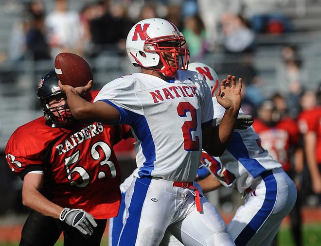 Natick's Scott McCummings, shown throwing a pass against Wellesley last fall, will play his college ball at the University of Connecticut.