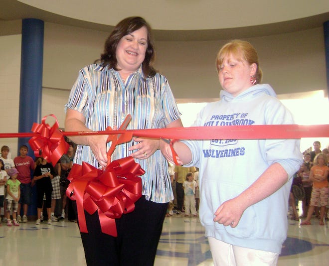 Former Prairie Hill School Board Member Colleen Bell cuts the ribbon at Willowbrook Middle School Monday, Aug. 17, 2009, in South Beloit. About 300 to 400 students, parents and teachers toured the new energy-efficient school. Bell was one of the board members who spearheaded Willowbrook to be LEED-certified by the U.S. Green Building Council, which provides environmentally sustainable construction standards.