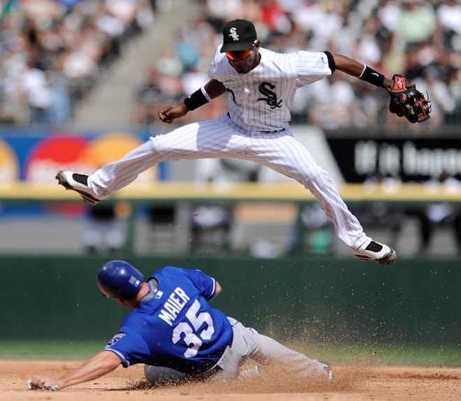 Chicago White Sox shortstop Alexei Ramirez jumps over Kansas City Royals' Mitch Maier after forcing him out at second base in the eighth inning in Chicago, Wednesday, Aug.19, 2009. Chicago won 4-2.