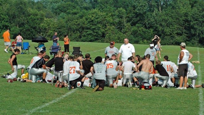 Everybody gather around: The third annual Hog Roast and football scrimmage took place Saturday at Washington Community High School. Panther head football coach Darrell Crouch, in white, addresses members of the team.