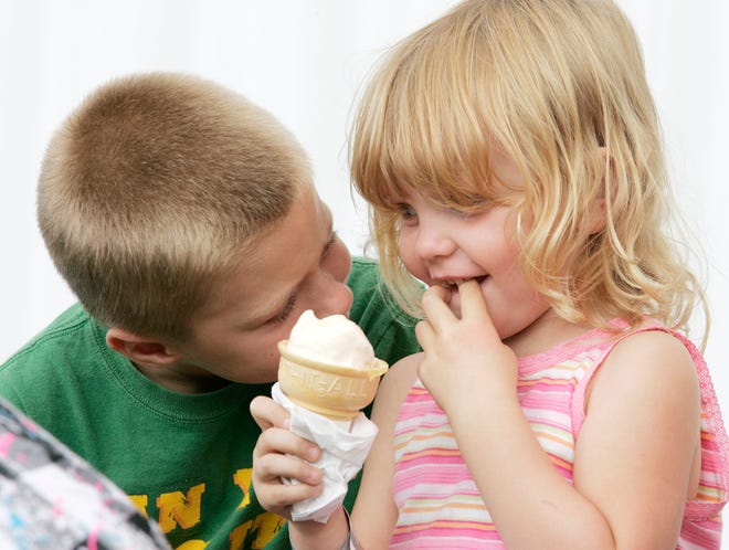 Austin Mitchel, 7, of German Valley watches his cousin Tiffany Deen, 4, of Leaf River eat a vanilla ice cream cone during the Winnebago County Fair on Saturday, Aug. 22, 2009, at the Winnebago County Fairgrounds in Pecatonica.