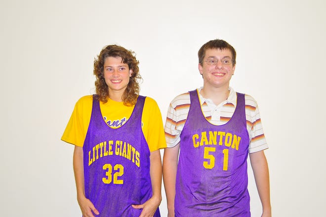 Special Olympics seniors Brittany Hart (number 32) and Matt Bitner (number 51) display their jerseys which will now be retired. Not pictued is Nick Denning (number 45) whose jersey will also be retired. The seniors are recognized for their hard work for the team.