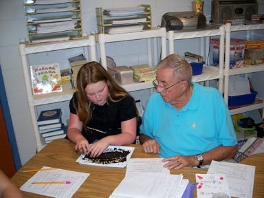 Walter Anderson, 85, better known as Mr. A, works with student Briana Starnes in Patti Hitt's class at Southport Elementary School.