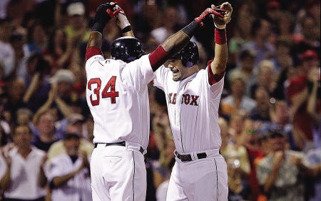Boston’s Mike Lowell is congratulated by teammate David Ortiz, left, after a three-run home run off Chicago starter Jose Contreras in the third inning Monday at Fenway Park.