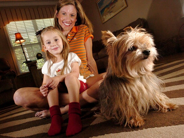 Kimberly Speas sits with her daughter Skylar Speas, 4, and Fonzie, her 14-year-old terrier, in their Leland home Monday Aug. 24, 2009.