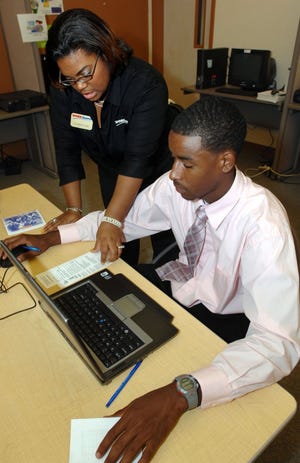 RICK WILSON/The Times-UnionWorkSource employee Dyamond Case (left) assists Edward Waters College student Michael Stevenson with his search for a job opportunity.