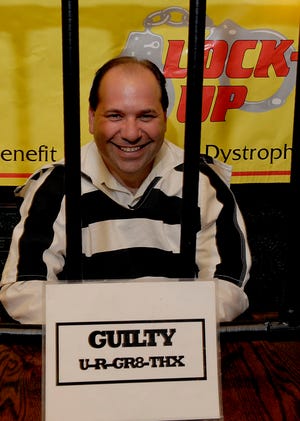 Jailbird Dan Fritz, of the Framingham Red Roof Inn, waits to be bailed out yesterday at John Harvard's Brew House. More than 50 people were "arrested," raising nearly $20,000 during the Muscular Dystrophy Association jail and bail event.