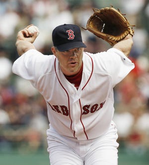 Red Sox pitcher Paul Byrd winds up to throw a pitch during Boston's 7-0 win over the Blue Jays.