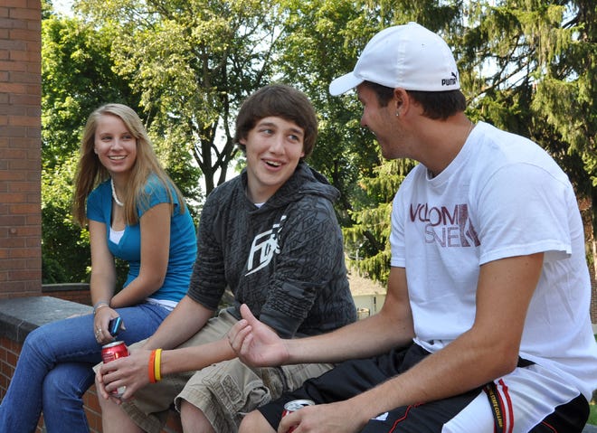 Framingham State College freshmen, from left, Kayla Surozenski of Brimfield, Kevin Cousineau of Ware and Dan Gallagher of West Springfield settle in to their new surroundings on Sunday.