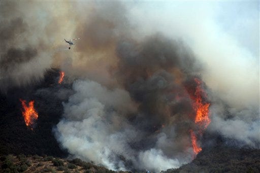 Fires burn near homes in City Oak Glen, San Bernadino, Calif. on Monday, Aug. 31, 2009.