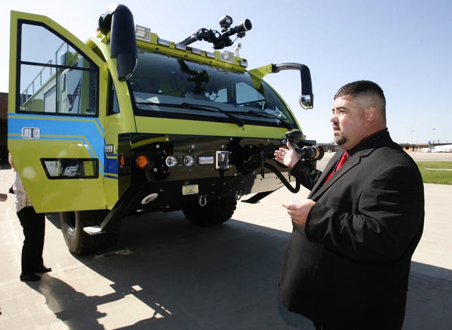 Todd Laps, public safety/operations manager, shows off a new new fire truck at the Akron-Canton Airport on Tuesday.