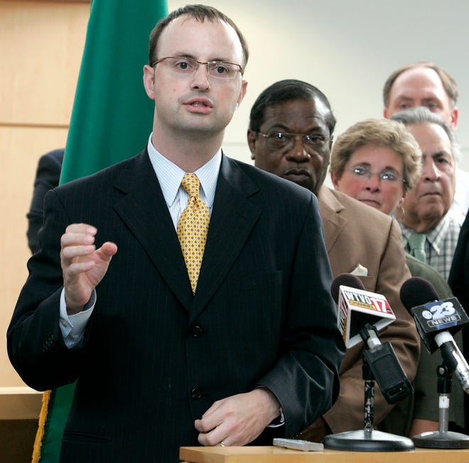 With local members of the clergy and city officials watching Rockford Mayor Larry Morrissey speaks Wednesday, Sept. 2, 2009, during a press conference to discuss his plan to work with the Department of Justice to facilitate a community dialogue on the recent police shooting and improving the community.