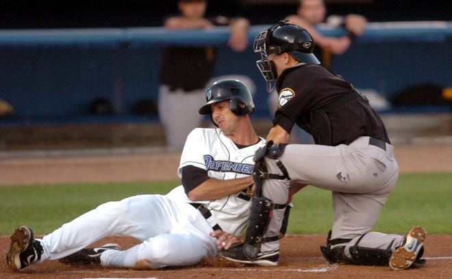 Defenders Josh Phelps is tagged out by Fisher Cats catcher Brian Jeroloman during the bottom of the second inning.