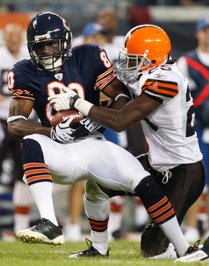 Chicago Bears wide receiver Earl Bennett is stopped by Cleveland Browns defensive back Coye Francies during the first half on Thursday, Sept. 3, 2009, in Chicago.
