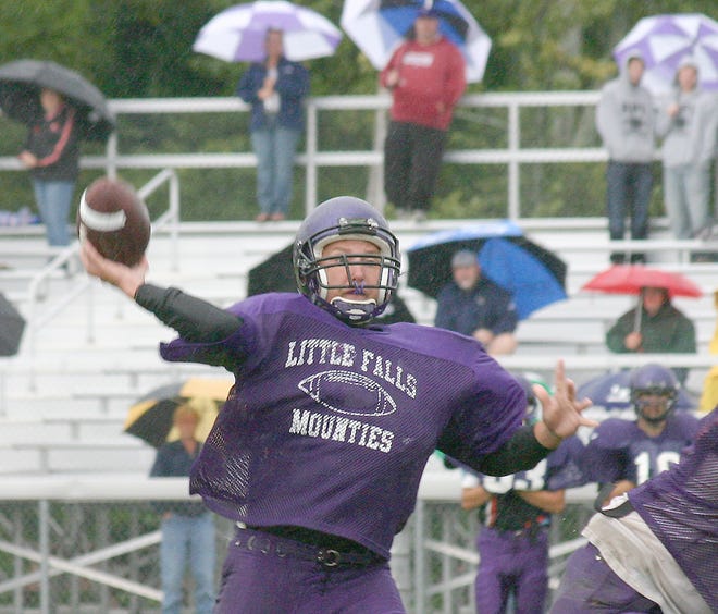 Third-year starting quarterback Alex Chlus puts up a paass in the rain during Little Falls’ scrimmage Saturday.