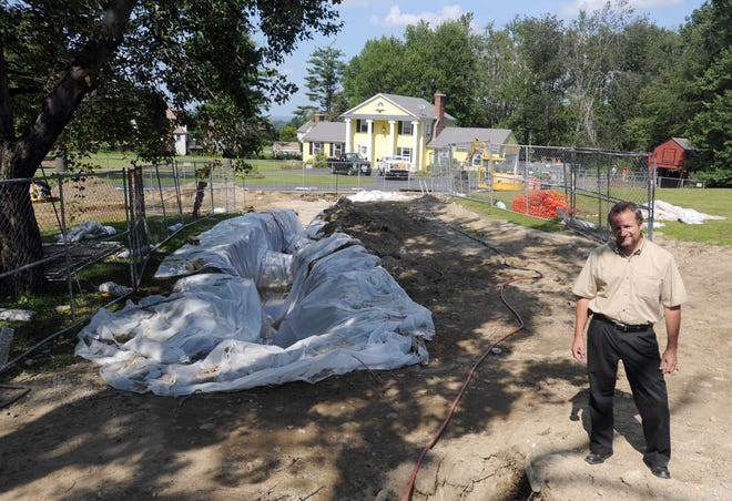Auburn Director of Public Health Andrew R. Pelletier stands near the Prospect Street house where an oil tank ruptured.