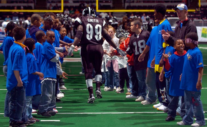 Young fans in the Treasure Life program greet lineman Jamar Smith and the rest of the Peoria Pirates during player introductions in 2008 at Carver Arena.