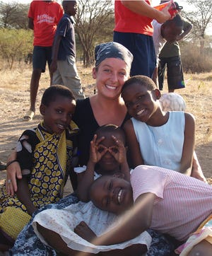 Janelle Rhodes, a 2001 graduate of Waynesboro Area Senior High School, poses for a picture with some of her students at the Lion of Judah Academy in Bulima, Tanzania, located in East Africa.