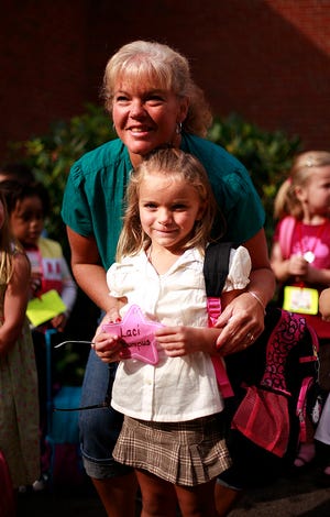 Five-year-old Laci Bumpus went to kindergarten for the first time Tuesday, the same school her mother and two aunts attended, the Ralph Talbot School in Weymouth. Mom Patti and Laci pose for a photo by aunt Joan.
