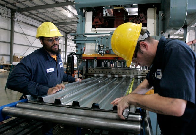 Alan Coleman (left) and Mike Knell work Wednesday, Sept. 9, 2009, at Infrastructure Defense Technologies in Belvidere moving steel through the fabrication process to make wall frames for perimeter defenses.