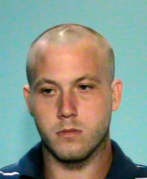 In this photo released on Sunday Aug. 30, 2009 by the Glynn County Police Department, Guy Heinze Jr. is shown. Heinze Jr., 22, who called 911 to report finding seven people slain in a dingy mobile home on a historic Georgia plantation, was arrested late Saturday and charged with illegal possession of prescription drugs and marijuana, tampering with evidence and making false statements to police, Glynn County Police Chief Matt Doering said. (AP Photo/Glynn County Police Department)
