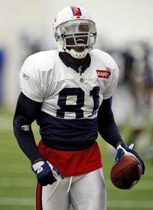 Buffalo Bills wide receiver Terrell Owens reacts after making a catch during NFL football practice inside the fieldhouse at Ralph Wilson Stadium in Orchard Park, N.Y., Wednesday, Sept. 9, 2009. (AP Photo/David Duprey)