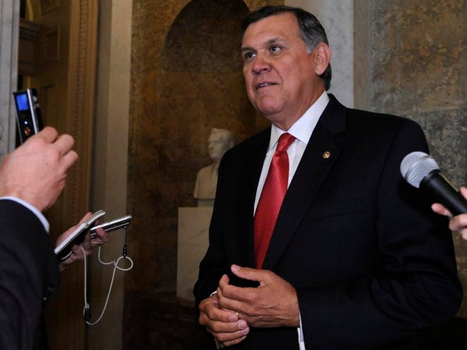 Outgoing Sen. Mel Martinez, R-Fla. takes to reporters on Capitol Hill in Washington, Wednesday, Sept. 9, 2009, after delivering his final speech.