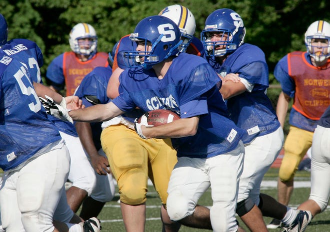 Scituate High School running back Morgan Billings picks up ground in a preseason scrimmage against Norwell.