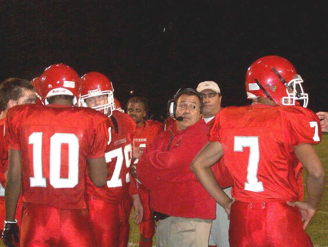 Fitchburg High football coach Ray Cosenza, center.
